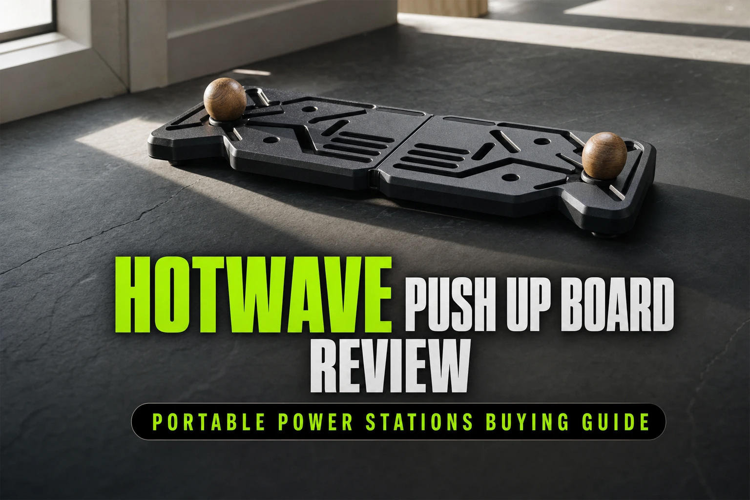 A folding multi-angle training platform rests centered on a slab of dark, honed slate, its vibrant color-coded grip slots creating a rhythmic geometric pattern.